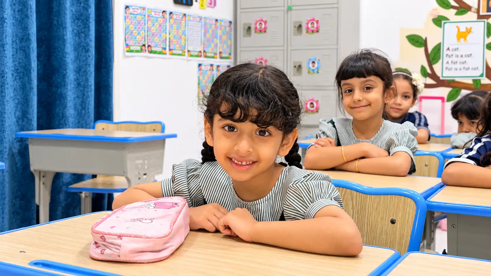 A.F.S Grade 1 pupils smiling at their desks